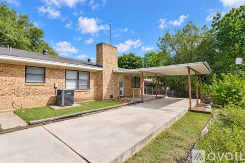 A house with a driveway and a covered walkway.