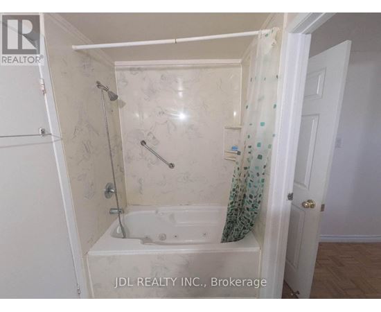A small bathroom with a bathtub and a shower.