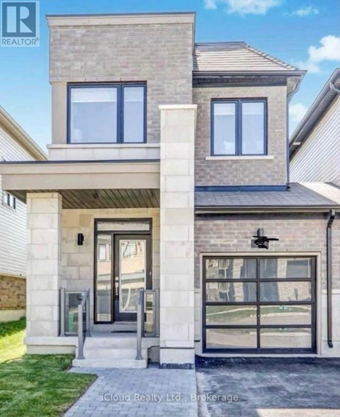 A modern house with a glass door and a stone pillar in front.