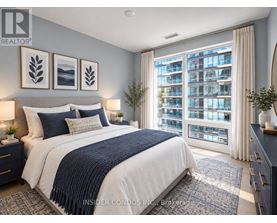 A bedroom with a large bed and a view of a building outside the window.