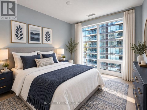 A bedroom with a large bed and a view of a building outside the window.