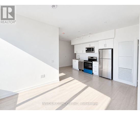 A kitchen with white cabinets and stainless steel appliances.