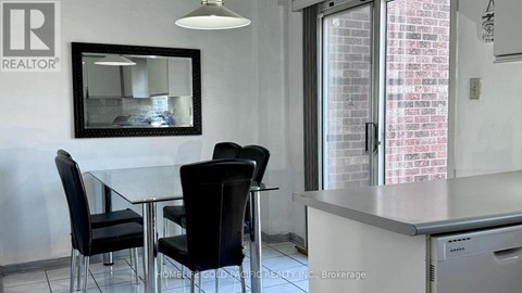 A dining room with a table and chairs.