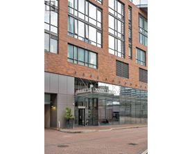 A building with a brick facade and a glass entrance.