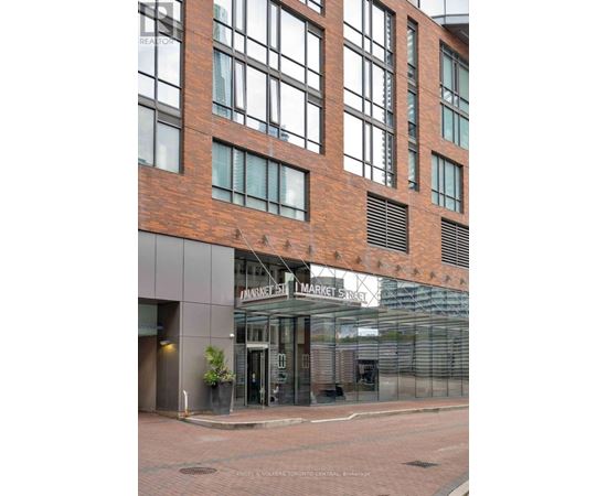 A building with a brick facade and a glass entrance.