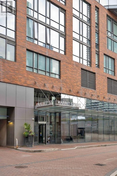A building with a brick facade and a glass entrance.
