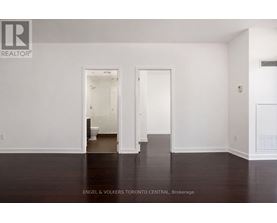 A white room with a doorway leading to another room.