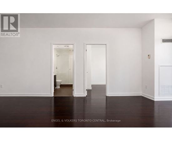 A white room with a doorway leading to another room.