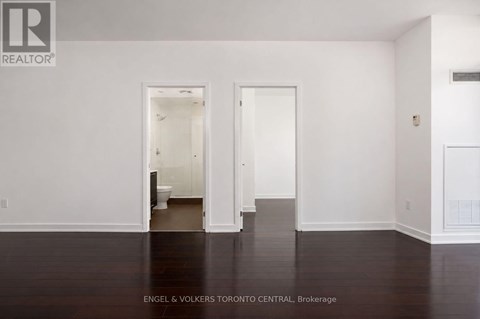 A white room with a doorway leading to another room.