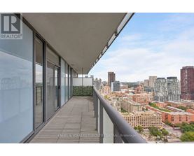 A balcony with a view of a city skyline.
