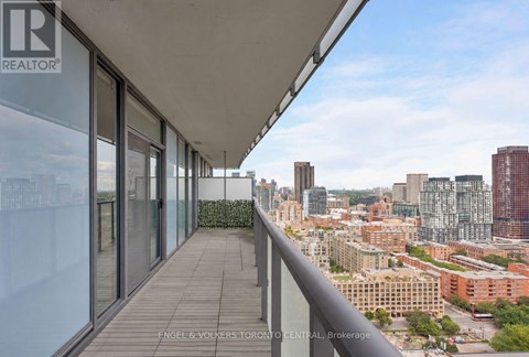 A balcony with a view of a city skyline.