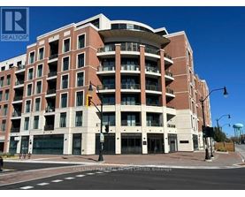 A large apartment building with a curved top floor and balconies on the upper floors.