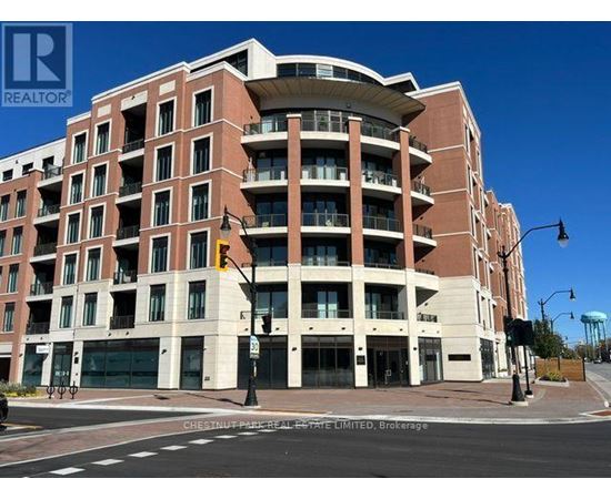 A large apartment building with a curved top floor and balconies on the upper floors.