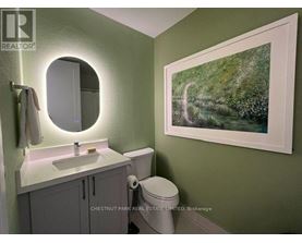 A bathroom with a green wall and a white sink.