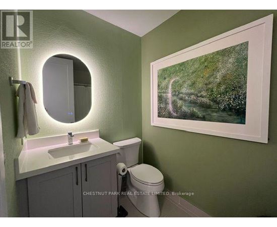 A bathroom with a green wall and a white sink.