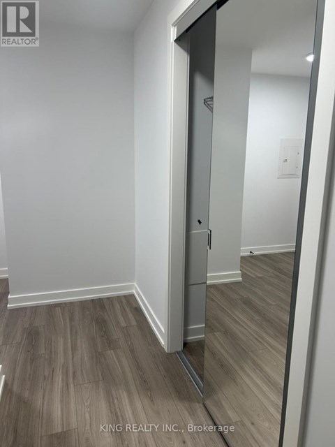 A brokerage office with wood flooring and white walls.