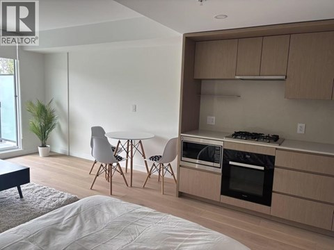 A modern kitchen with a dining table and chairs.