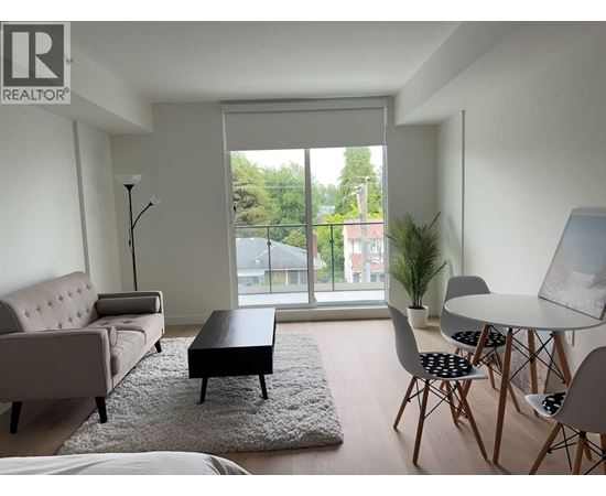 A living room with a couch, chairs, and a table.