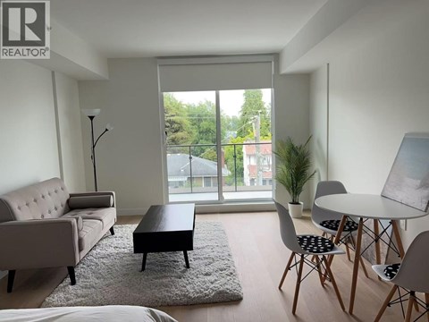 A living room with a couch, chairs, and a table.