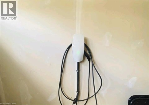 A white power strip plugged into a wall socket.