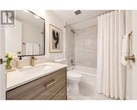 A bathroom with a sink, toilet, and bathtub.