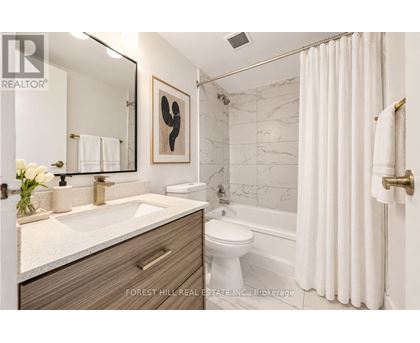A bathroom with a sink, toilet, and bathtub.