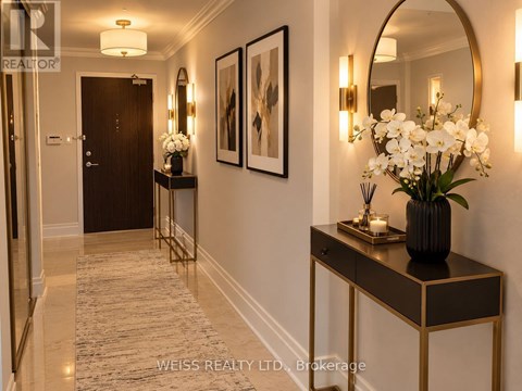 A hallway with a console table and a mirror on the wall.