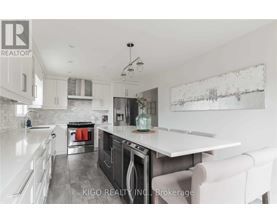 A modern kitchen with white cabinets and a large island.