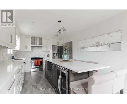 A modern kitchen with white cabinets and a large island.