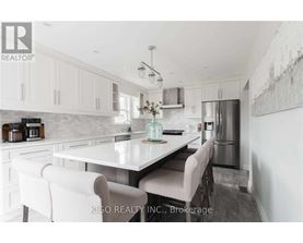 A modern kitchen with white cabinets and a central island.