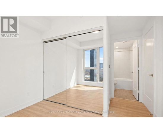 A room with a sliding glass door leading to a balcony.