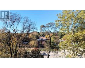 A house surrounded by trees in autumn.
