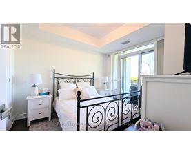 A bedroom with a black metal bed frame and white bedding.
