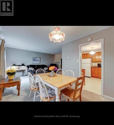 A dining room with a wooden table and chairs.