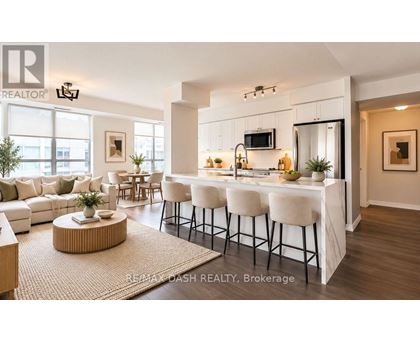 A modern kitchen with white cabinets and a bar area.
