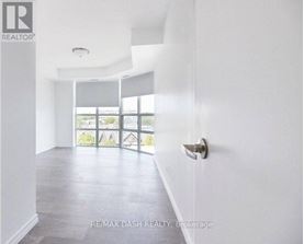 A white room with a door and a window.