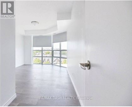 A white room with a door and a window.