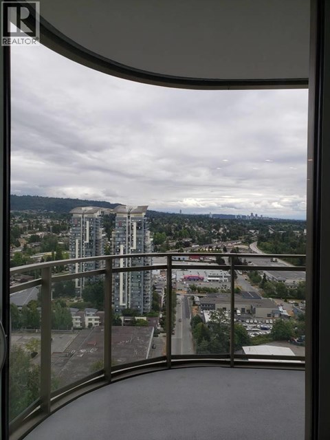 A view from a balcony looking out at a cityscape.