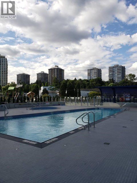A swimming pool with a metal ladder in the middle of it.