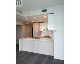 A modern kitchen with a sink and a counter.