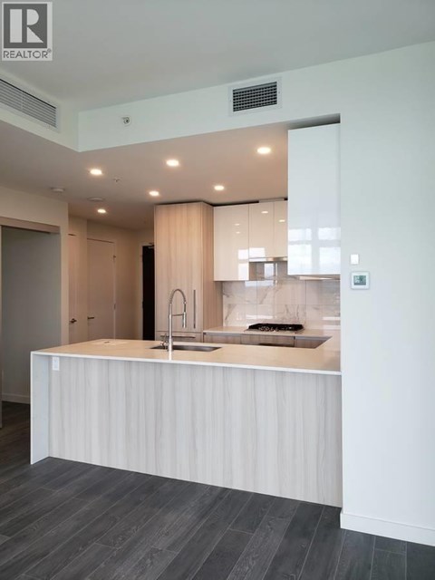 A modern kitchen with a sink and a counter.