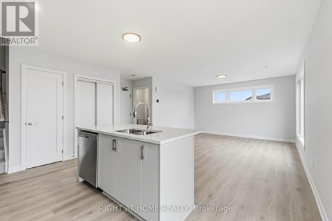 A kitchen area with a sink and cabinets.