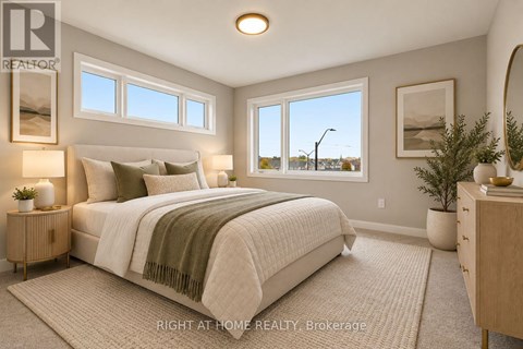 A well-lit bedroom with a large bed and a view of the street outside the window.