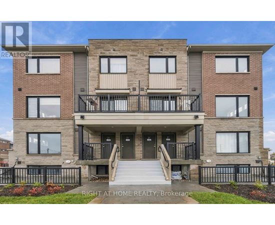 A multi-story residential building with a balcony on the second floor.