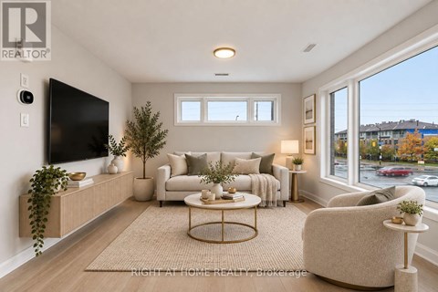A living room with a large flat screen TV mounted on the wall.