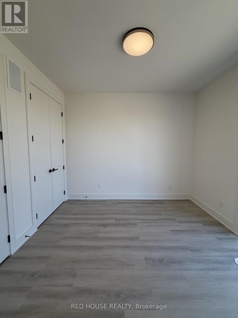 A room with a wooden floor and white walls.
