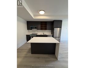 A modern kitchen with a white island in the middle.