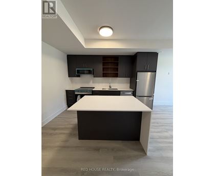 A modern kitchen with a white island in the middle.