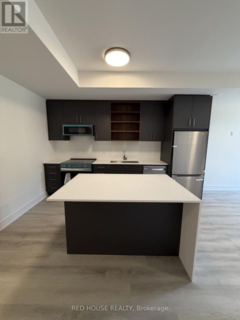A modern kitchen with a white island in the middle.