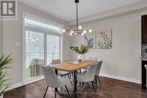 A dining room with a wooden table and chairs.